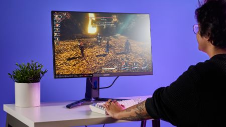 A person playing Clair Obscur: Expedition 33 on a Lenovo Legion R27qe Gen 2 gaming monitor