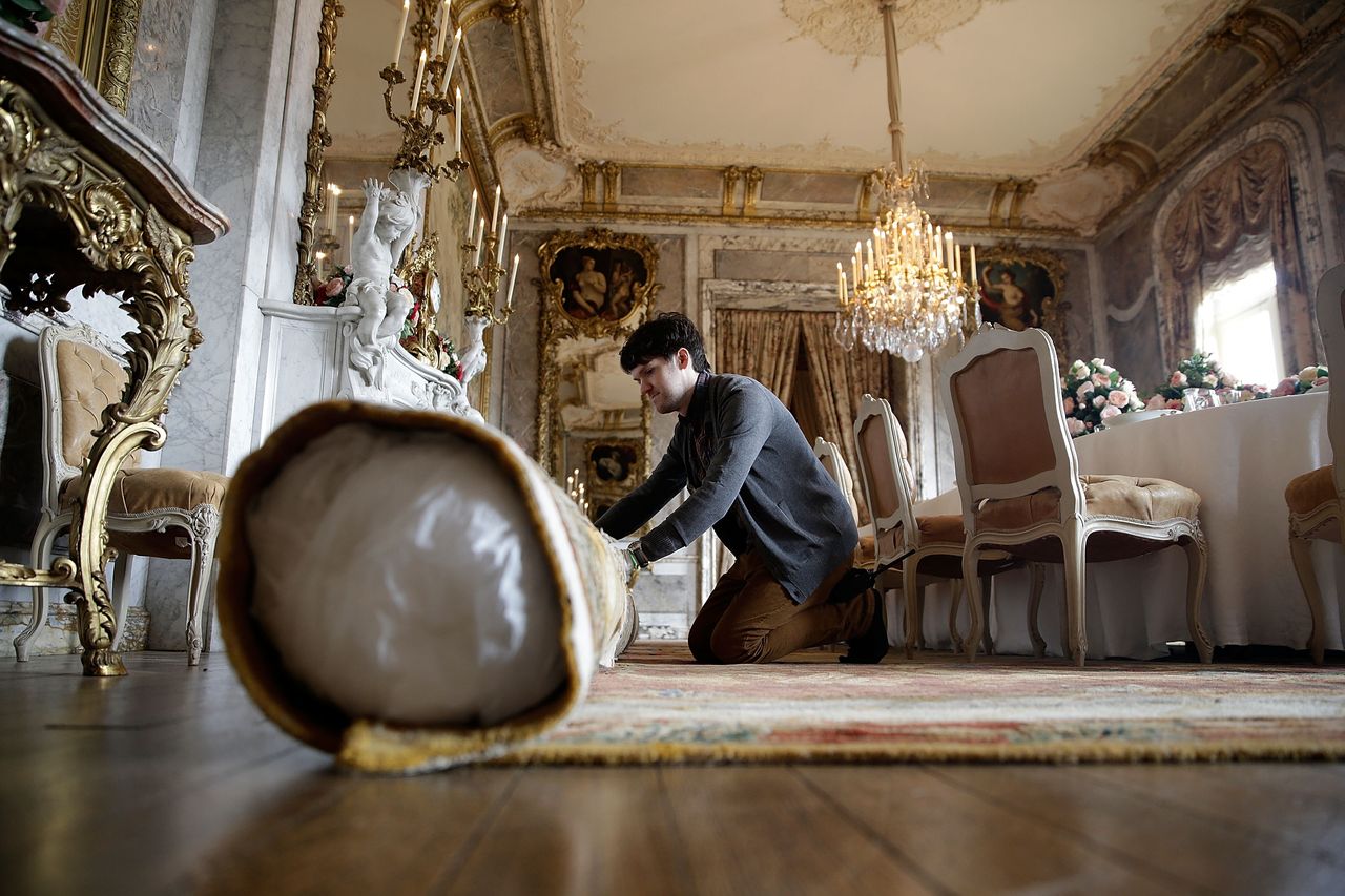 AYLESBURY, ENGLAND - MARCH 22: AYLESBURY, ENGLAND Ð MARCH 22: National Trust employees adjust decorations in the dining room at Waddesdon Manor on March 22, 2013 in Aylesbury, England. The staff at Waddesdon Manor are busy preparing the house and gardens for the spring opening. The light-artist Bruce Munro has also created a new installation in the coach house called Cantus Arcticus. Waddesdon Manor is open to the general public fromÊ March 27, 2013 to October 27. (Photo by Matthew Lloyd/Getty Images for Waddesdon Manor)