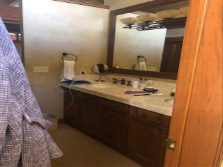 A dated bathroom with a double vanity sink