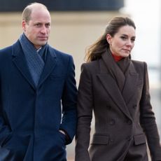 Prince William wears a navy coat and Kate Middleton wears a brown coat during 2022 Boston visit