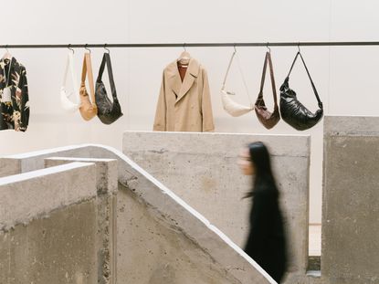 Best fashion stores: inside of Lemaire store in Paris with rail of clothing and croissant handbags