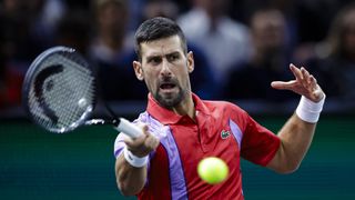 Tennis icon Novak Djokovic of Serbia, dressed in a red Lacoste shirt, plays a forehand in preparation for the ATP Finals 2023