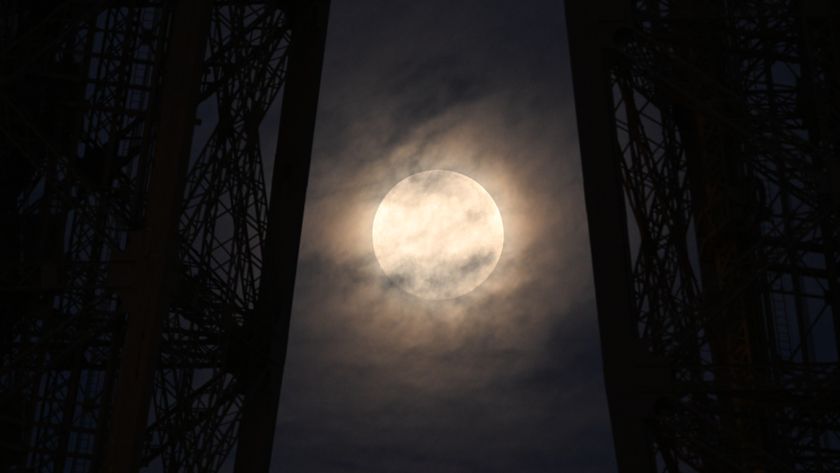 A photo of the &quot;Cold Supermoon&quot; behind the Eiffel Tower in Paris. 