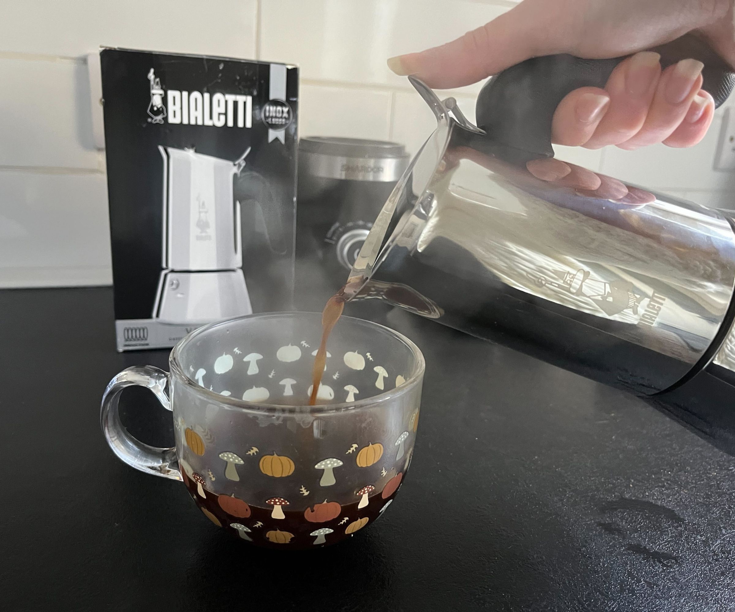 Pouring coffee from the Bialetti Venus into a glass mug