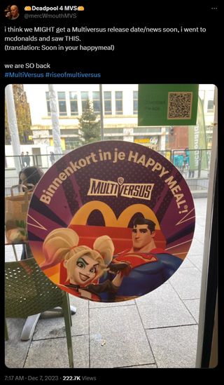 A screenshot of a tweet from @mercWmouthMVS, reading "I think we MIGHT get a Multiversus release date/news soon, i went to mcdonalds and saw THIS. we are SO back". Attached is a photograph of an in-store advertisement from a Belgian McDonald's, showing the renderings of Superman and Harley Quinn from Multiversus with the caption "Soon in your happy meal" written in Dutch.