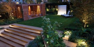 a sloping garden with lots of lighting ideas