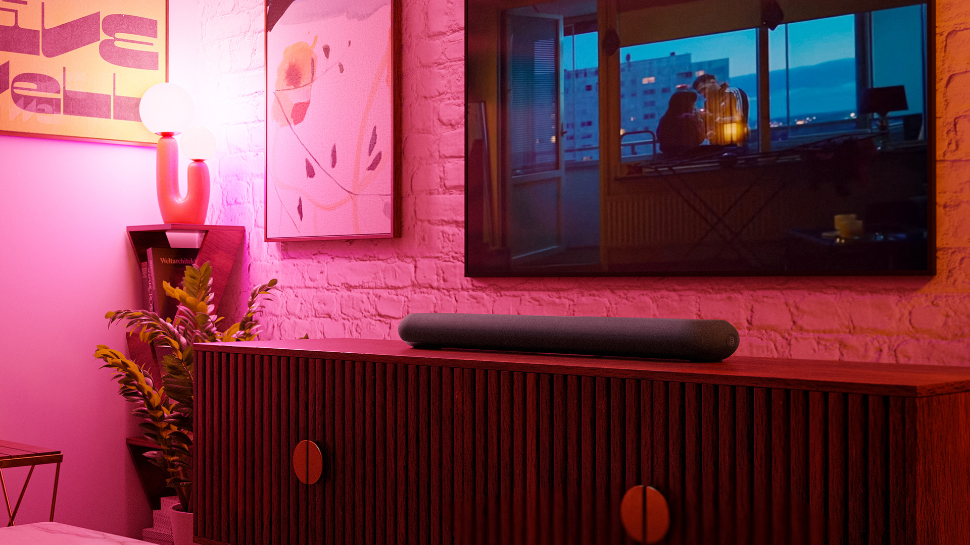 Promotional images showing Bluesound's Pulse home cinema in action