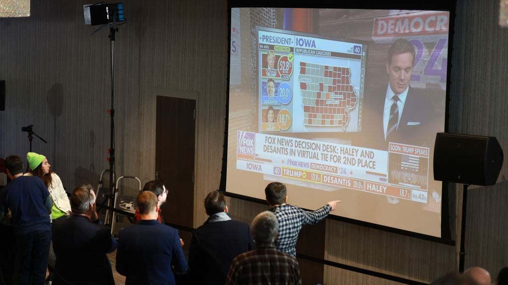 Attendees of Nikki Haley&#039;s 2020 Iowa Caucus party watch Fox News