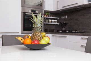 A fruit bowl on a kitchen counter.