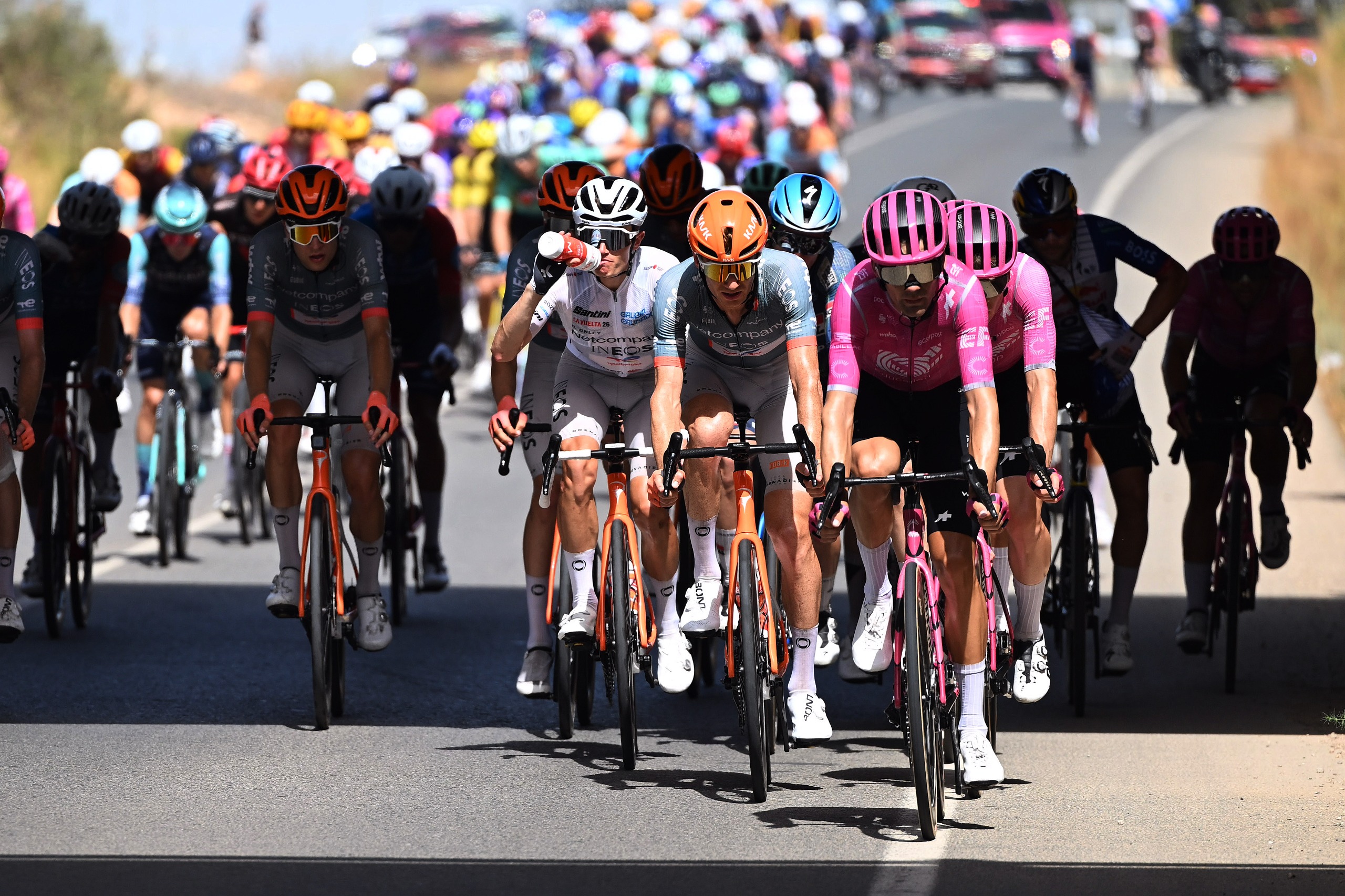 Jack Haig leads Oscar Onley (taking a drink) during stage 11 of the Vuelta a Espana