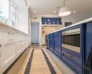 Contrast kitchen scheme with indigo island and jute floor runner