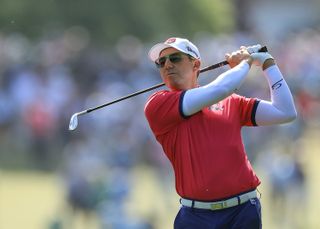 Sergio Garcia hits an iron shot and watches its flight