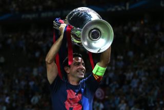 Xavi lifts the Champions League trophy after Barcelona's win in the 2015 final, his last game for the Catalan club.