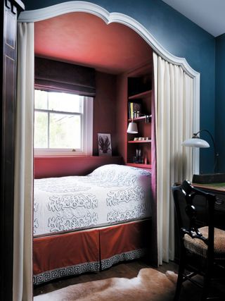 Small bedroom with built in bed and a curtain
