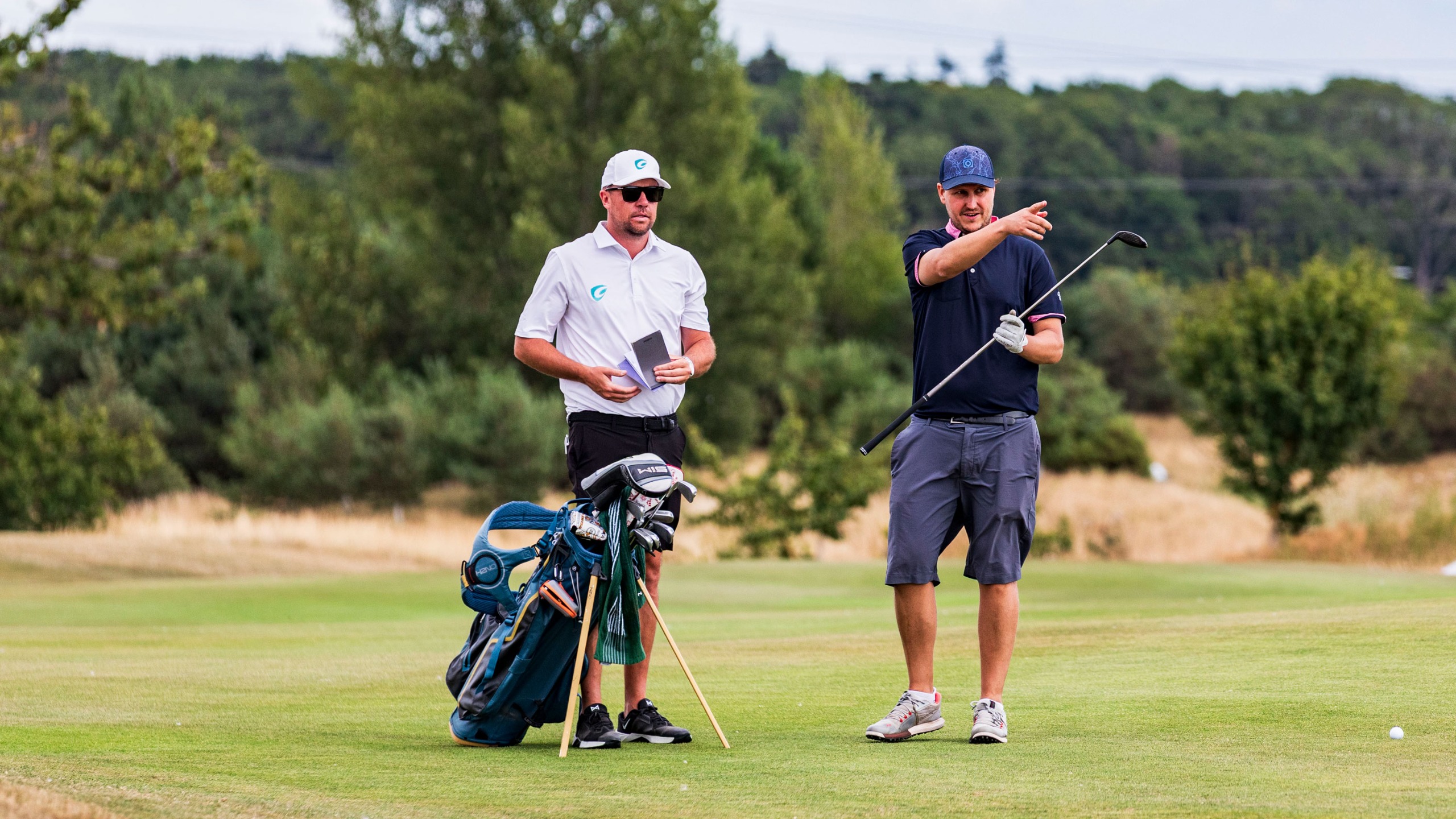 Nick Bonfield talks with caddie Jonathan Smart to develop a summer golf strategy