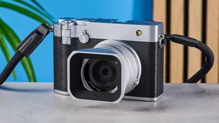 A black and silver Fujifilm GFX100RF medium format camera