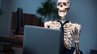 Skeleton sat at a laptop