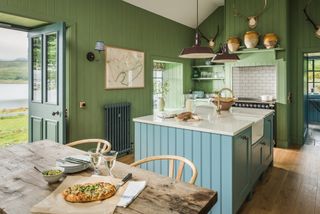 green kitchen with shaker cabinets and teal island