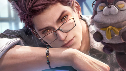 Valko poses with a stuffed wolf wearing glasses