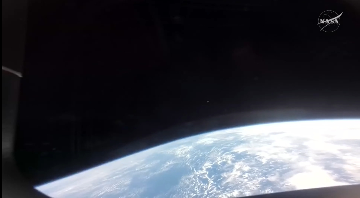 a view of earth and a thin layer of atmosphere