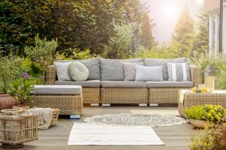 outdoor furniture with grey cushions and pillows