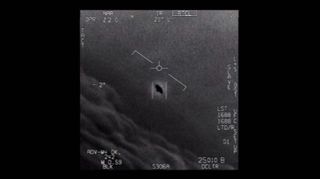 A screenshot from a video depicting a blurry, unidentified object tracked by a U.S. Navy F/A-18. 