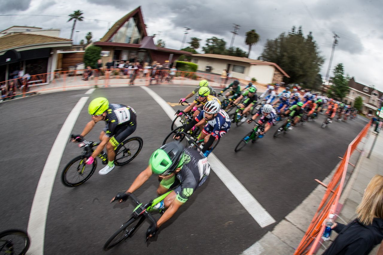 The peloton speeds through one of the tight turns on the course.