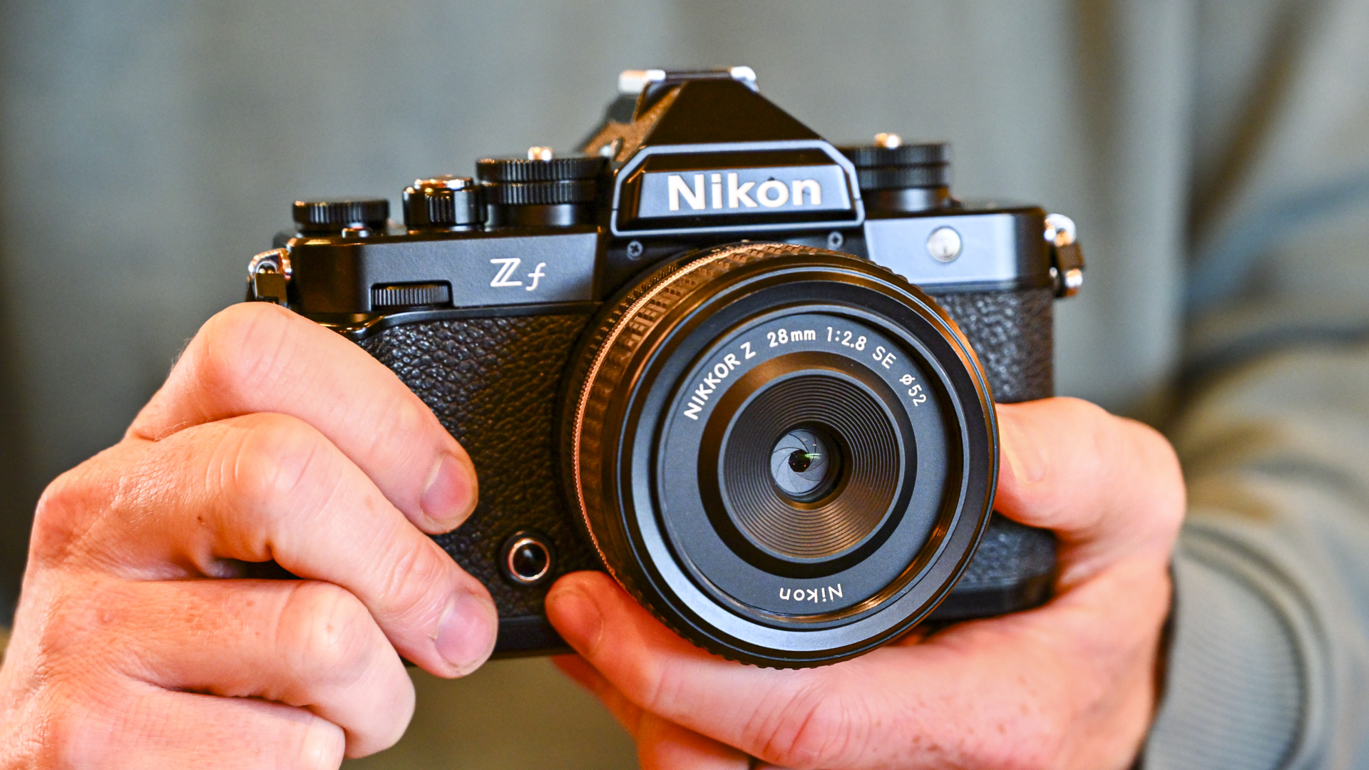 Nikon Zf camera in the hand with Z 28mm F2.8 SE lens attached