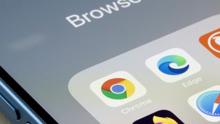 Google Chrome app is seen on an iPhone next to Edge and other web browser apps. Microsoft is using new prompts in Edge to try and stop users from downloading Chrome.
