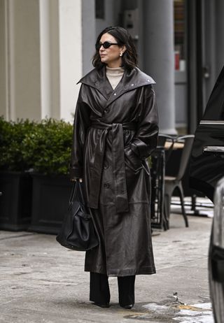 A guest wears a black duster jacket during New York Fashion Week's Fall/Winter 2025 shows