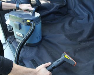 Camryn Rabideau demonstrating how to use the Shark MessMaster vacuum and carpet cleaner carpet tool to remove pet hair from inside her Jeep automobile