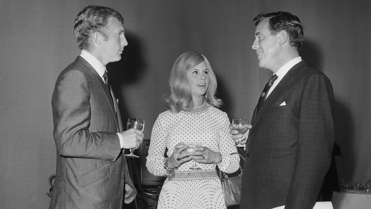 England captain Bobby Moore and his wife Tina talking to presenter Eamonn Andrews at the ITV Studios where they are recording a programme to celebrate Englands World Cup victory, 31st July 19