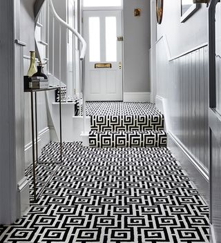 narrow hallway with black and white geometric floor carpet