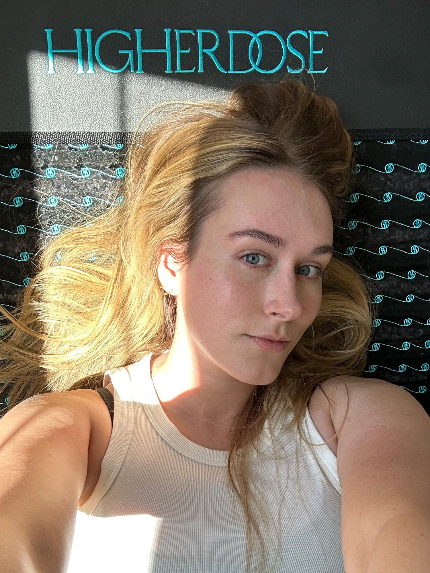 Who What Wear beauty editor Kaitlyn McLintock using HigherDose's Infrared PEMF Mat.