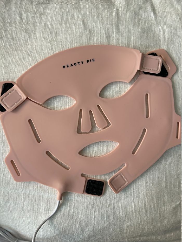 The new Beauty Pie LED mask on a white linen background