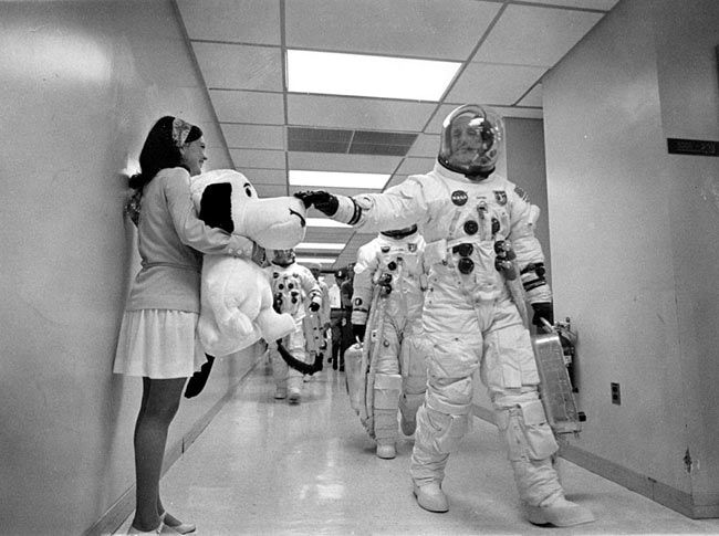Headed for the launch pad, Apollo 10 commander Tom Stafford pats the nose of a stuffed Snoopy held by Jamye Flowers (Coplin), astronaut Gordon Cooper's secretary.