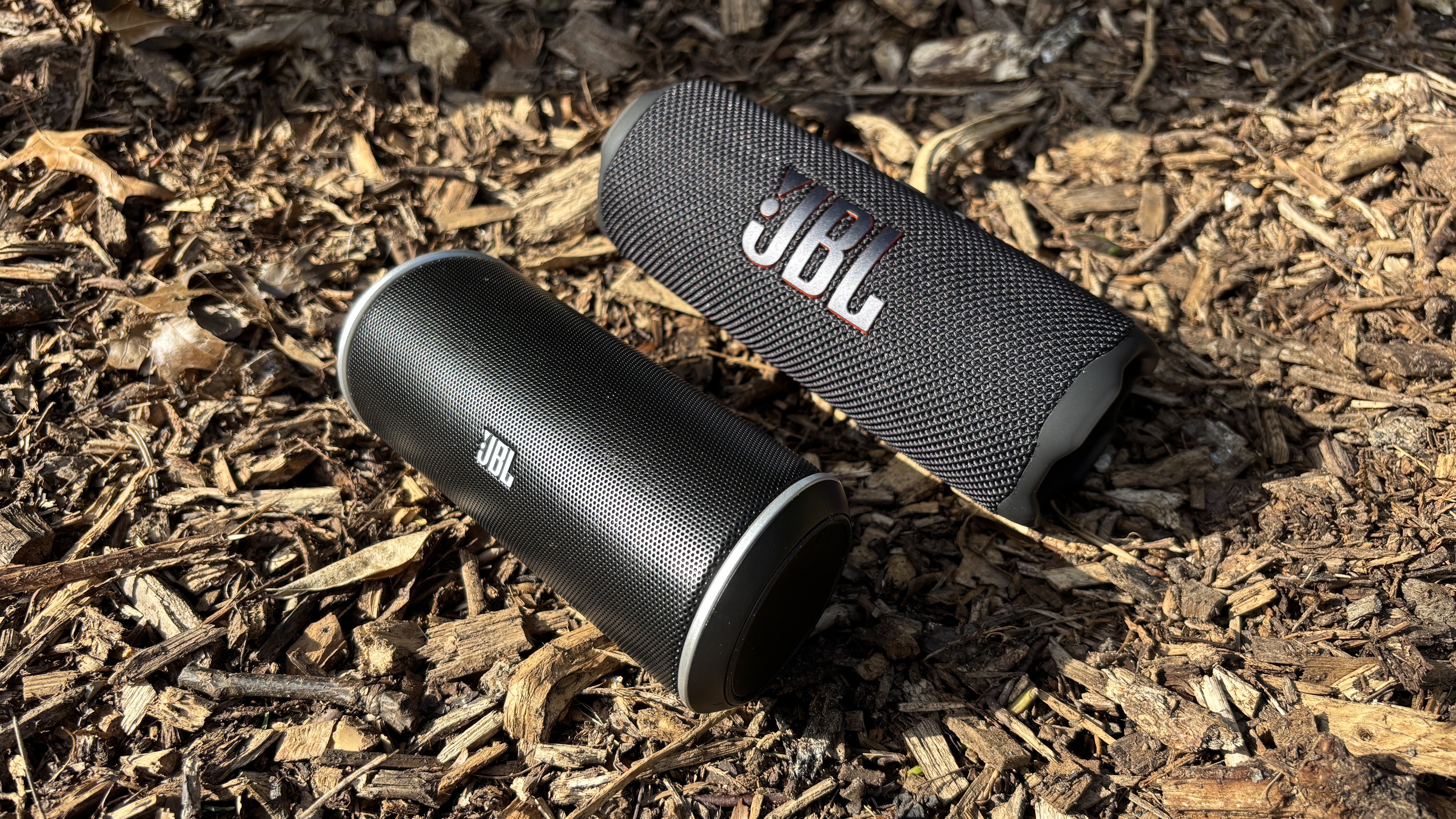JBL Flip 7 lying next to the original JBL Flip on the ground