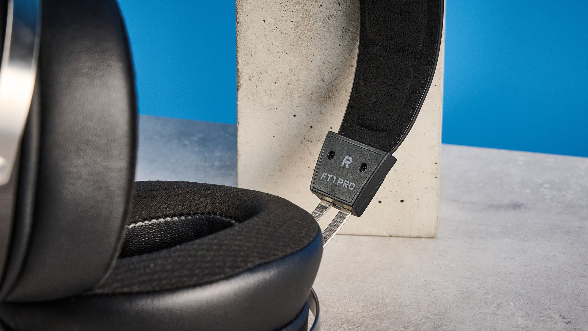 the fiio ft1 pro wired open-back headphones photographed with a blue tom's guide background