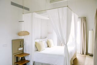 Hotel Torralbenc bedroom, white walls and white linens
