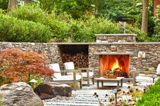 a backyard with a roaring fire and autumnal colors