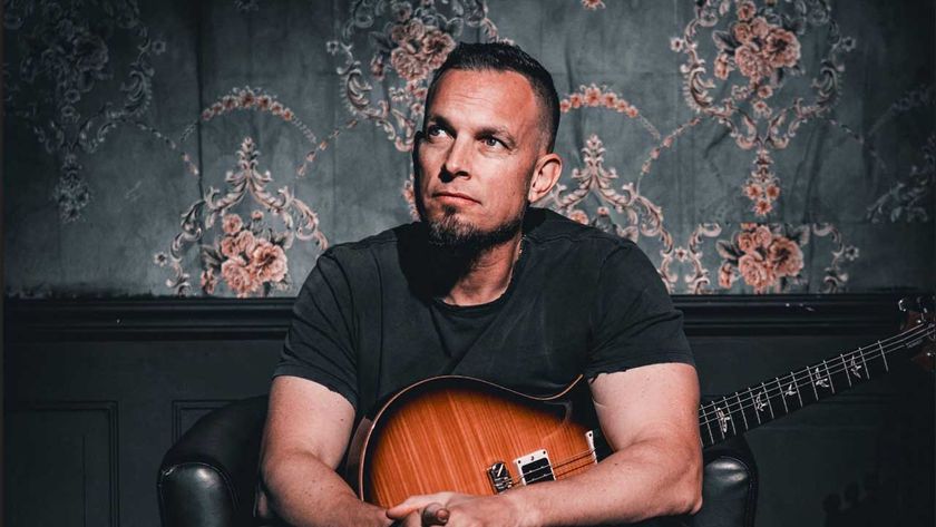 Mark Tremonti seated, holding an electric guitar