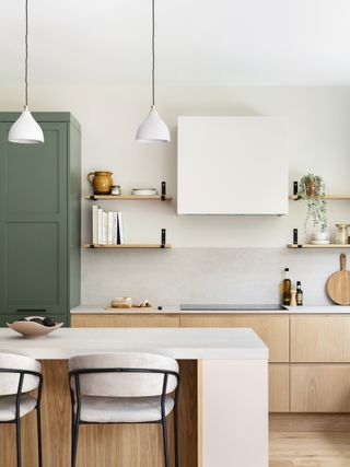 White kitchen with wooden kitchen cabinets by Naked Kitchens