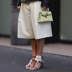 Woman in tan sandals with matching tan bag