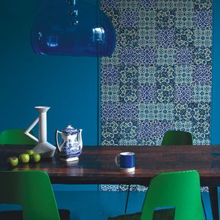 room with printed blue with green walls