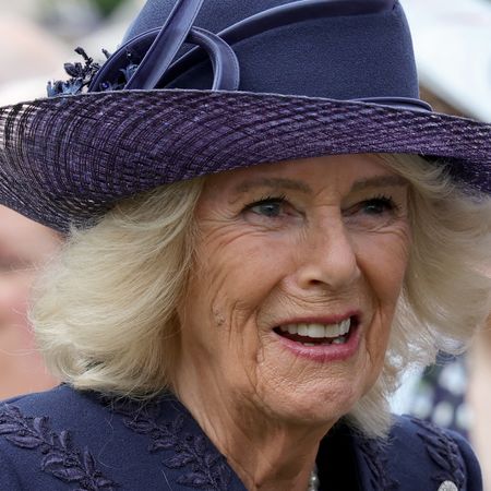 Queen Camilla wearing a blue hat and coat