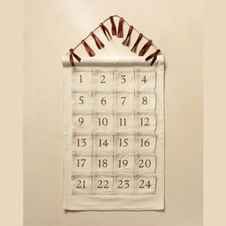 neutral fabric advent calendar with dark red numbers and red ribbon detail