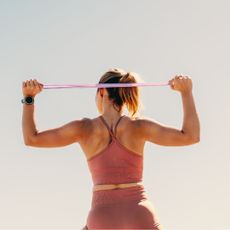 Resistance band workouts: A woman working out her shoulders using a resistance band