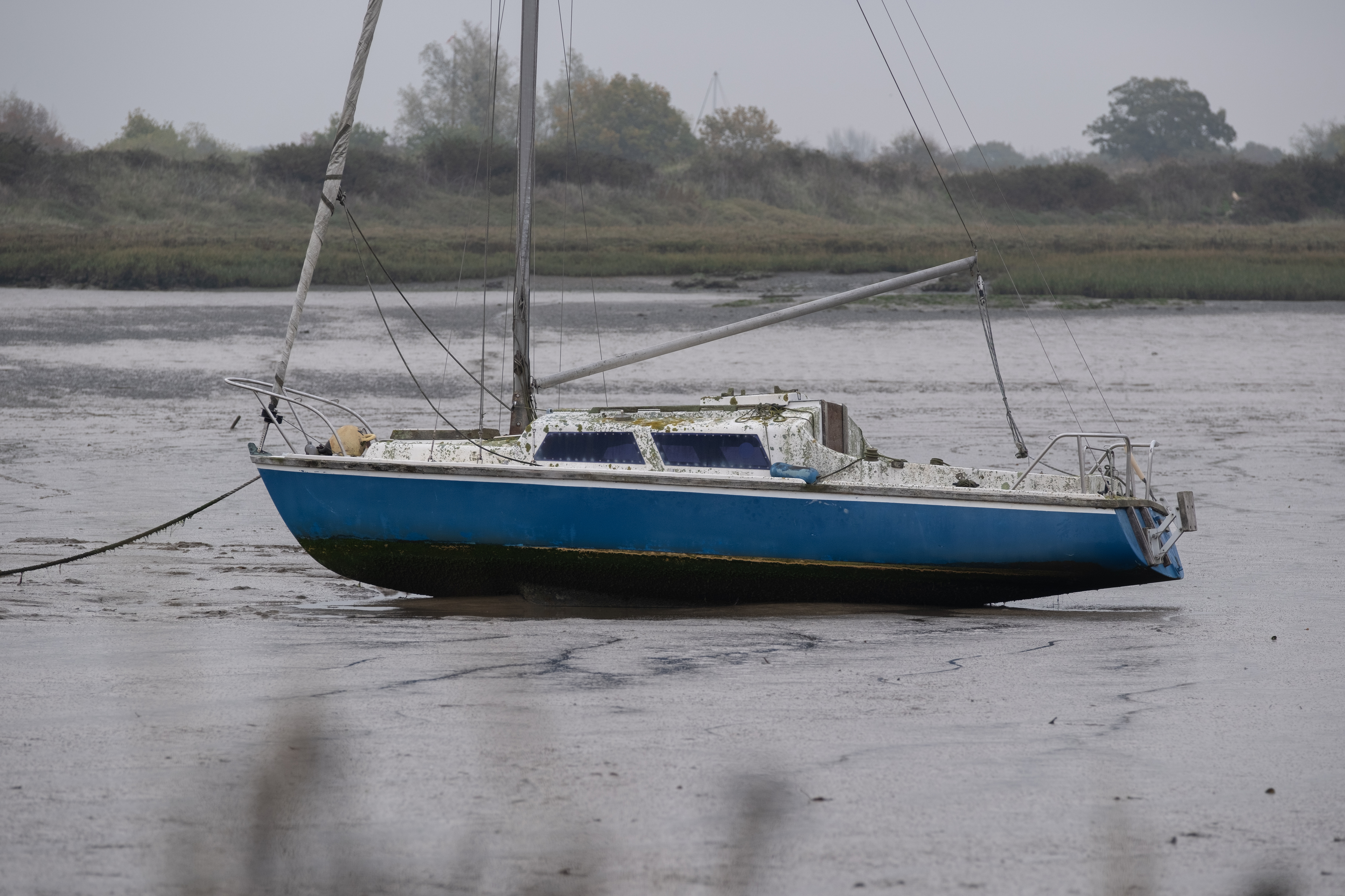 A boat on mud flats at low tide