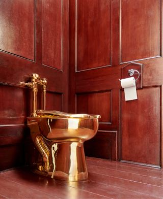 Golden toilet in wooden room