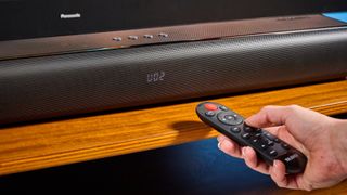 the budget majority naga 60 soundbar in black, showing its buttons and remote
